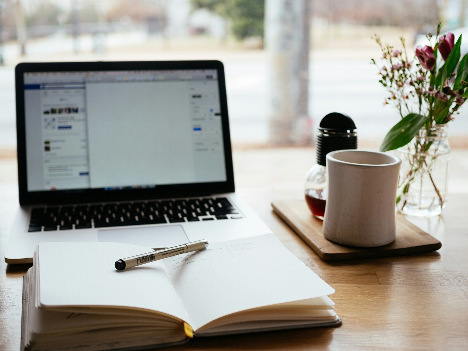 cozy-workspace-with-laptop-open-notebook-pen-and-coffee-mug